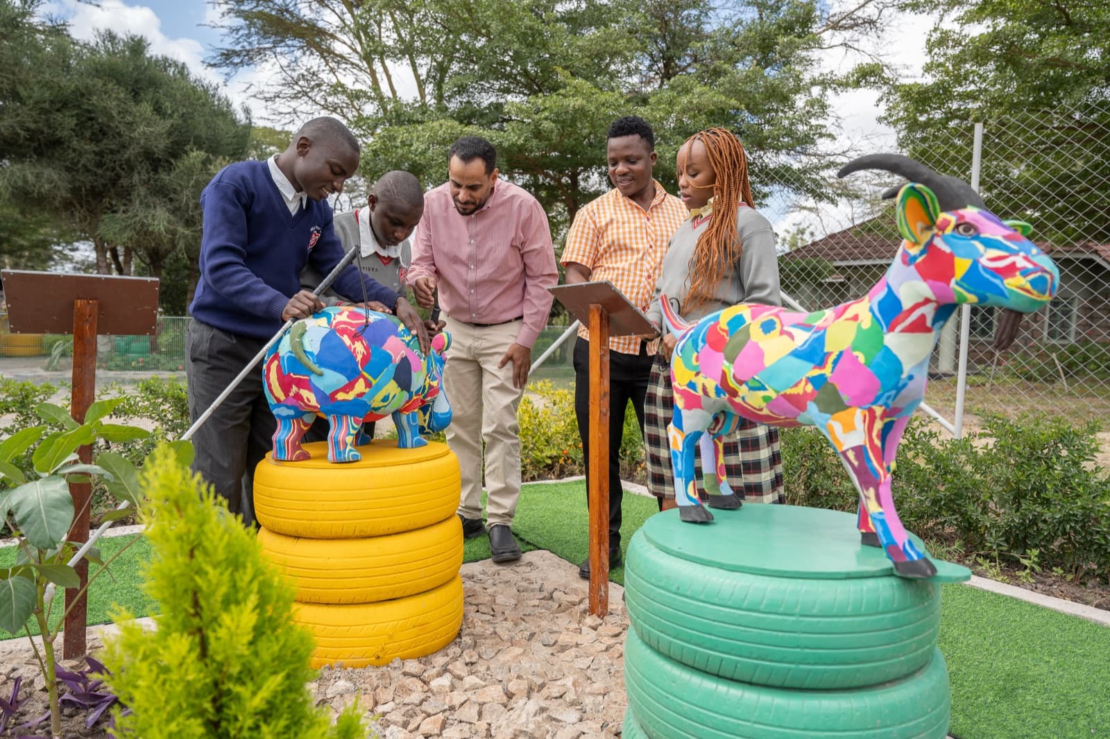 Students and staff at a community garden project — one of the local initiatives the Group supports